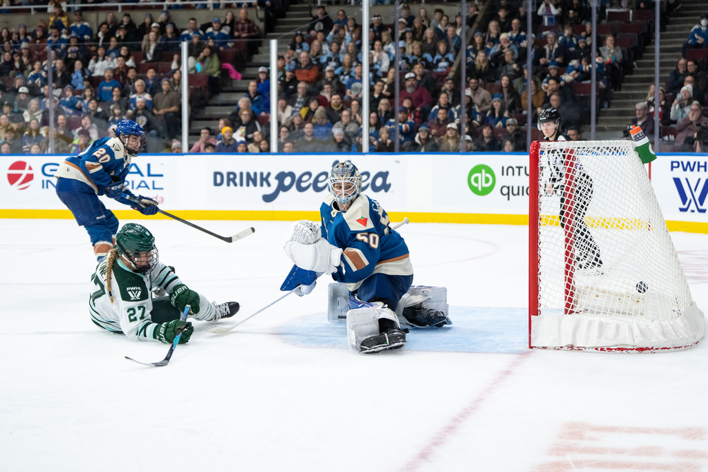Boston Fleet's Shay Maloney (27) scores on Vancouver Goldeneyes goaltender Kristen Campbell (50) as Sarah Nurse (20) watches during overtime of a PWHL hockey game in Vancouver, on Tuesday, March 10, 2026. (Ethan Cairns/The Canadian Press via AP)