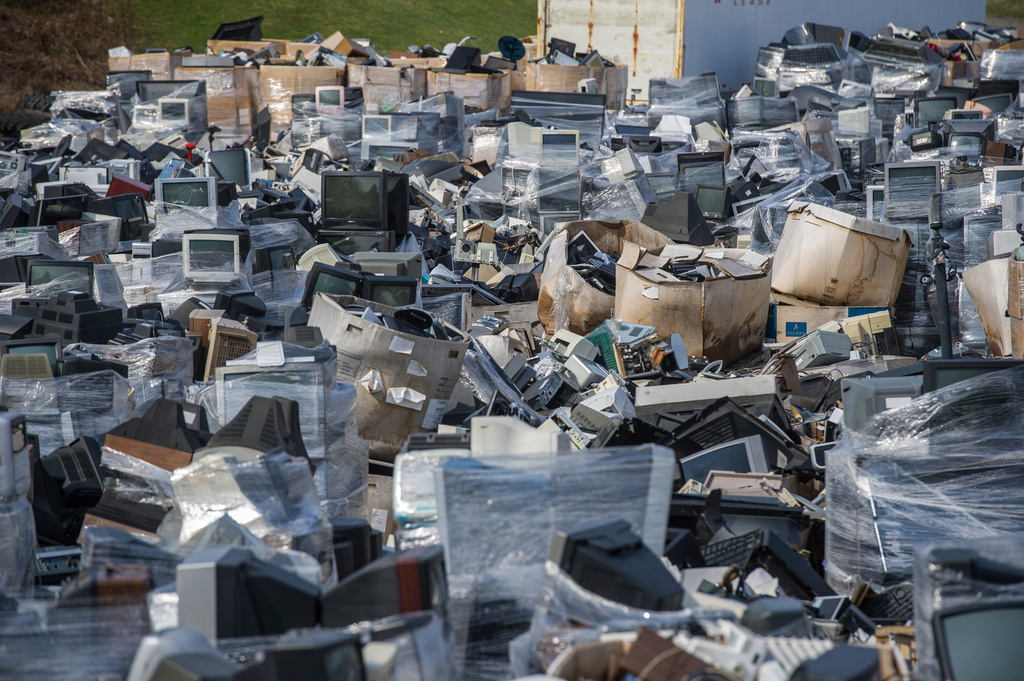 FILE - A sea of electronic waste, consisting mostly of televisions, microwaves and computers, cover the landscape at Westmoreland Cleanways and Recycling, in Unity, Pa., March 24, 2017. (Dan Speicher/Pittsburgh Tribune-Review via AP, File)