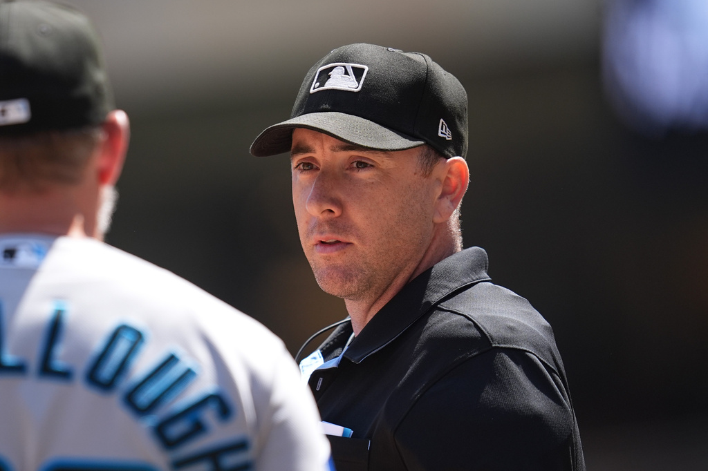 FILE - Miami Marlins manager Clayton McCullough (86), left, talks with home plate umpire Tom Hanahan during the second inning of a baseball game against the Minnesota Twins, Thursday, May 14, 2026, in Minneapolis. (AP Photo/Abbie Parr, File)
