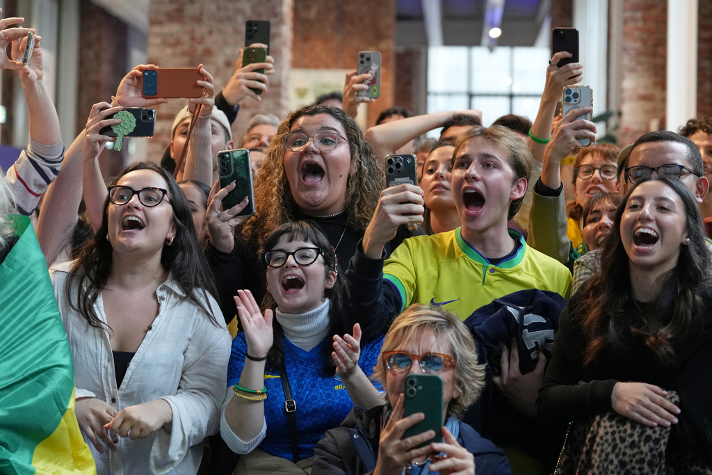 Supporters of Brazil's Lucas Pinheiro Braathen react at the Brazil House as he starts his second run in the men's giant slalom at the 2026 Winter Olympics, in Milan, Italy, Saturday, Feb. 14, 2026. (AP Photo/Antonio Calanni)