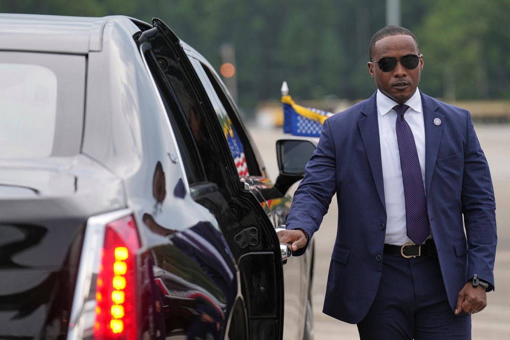 A member of the U.S. Secret Service stands before President Donald Trump arrives to board his limousine at Myrtle Beach International Airport in Myrtle Beach, S.C., Friday, Aug. 21, 2026. (AP Photo/Jacquelyn Martin)