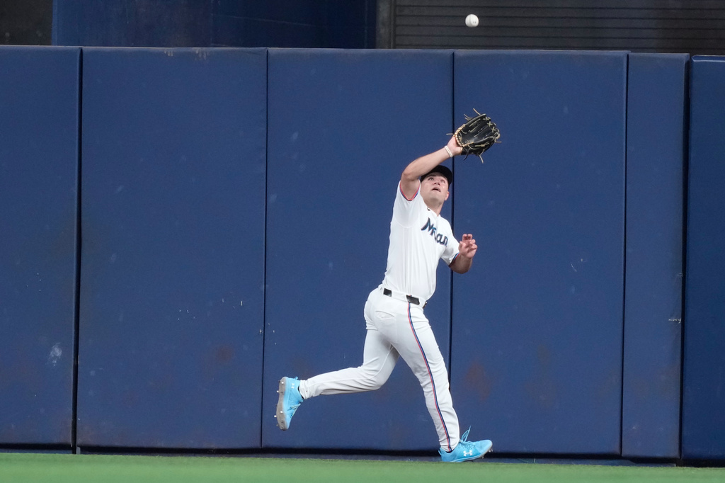 Miami Marlins center fielder Jakob Marsee fields a fly ball hit by Seattle Mariners' Cal Raleigh during the sixth inning of a baseball game, Wednesday, July 8, 2026, in Miami. (AP Photo/Lynne Sladky)