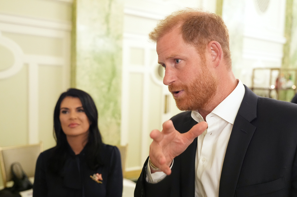 Britain's Prince Harry, the Duke of Sussex, speaks to The Associated Press after a roundtable about support for veterans, Wednesday, Aug. 19, 2026, in Washington, as Sarah Verardo, CEO, of The Independence Fund, listens. (AP Photo/Alex Brandon) CORRECTIONS: Corrects name to Verardo, instead of Verado