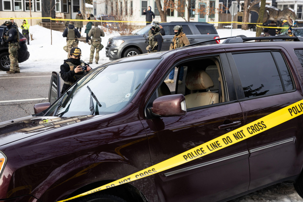 A bullet hole and blood stains are seen in a crashed vehicle on at the scene of a shooting in Minneapolis on Wednesday, Jan. 7, 2026. (Ben Hovland/Minnesota Public Radio via AP)