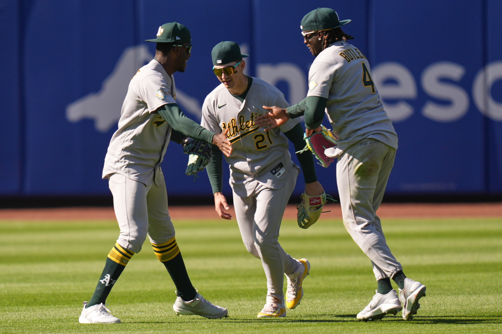Oakland Athletics outfielders Denzel Clarke, left, Tyler Soderstrom, center, and Lawrence Butler celebrate after a baseball game against the New York Mets, Sunday, April 12, 2026, in New York. (AP Photo/Seth Wenig)