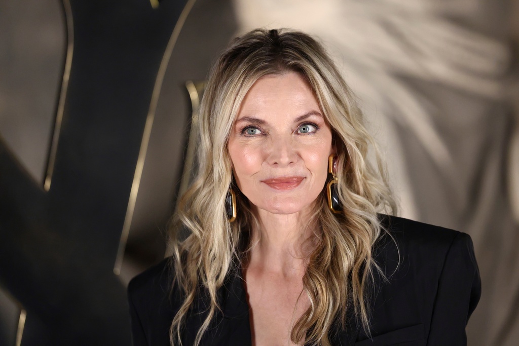 Michelle Pfeiffer poses for photographers upon arrival for the Saint Laurent Fall/Winter 2026-2027 Women's collection presented in Paris, Tuesday, March 3, 2026. (AP Photo/Tom Nicholson)