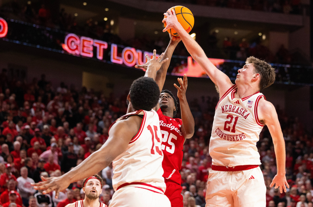 Nebraska's Pryce Sandfort (21) blocks a shot by Wisconsin's John Blackwell (25) as he shoots against Nebraska's Jared Garcia (15) during the second half of an NCAA college basketball game Wednesday, Dec. 10, 2025, in Lincoln, Neb. (AP Photo/Rebecca S. Gratz)