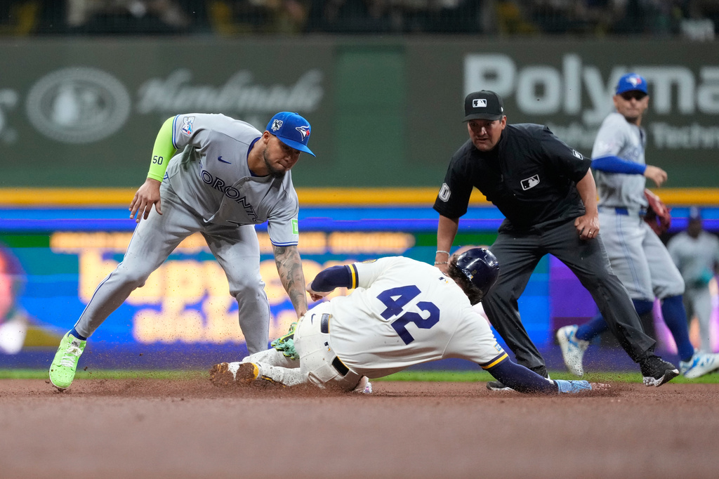 Toronto Blue Jays' Lenyn Sosa, left, tags out Milwaukee Brewers' Brice Turang at second base during the sixth inning of a baseball game Wednesday, April 15, 2026, in Milwaukee. (AP Photo/Aaron Gash)