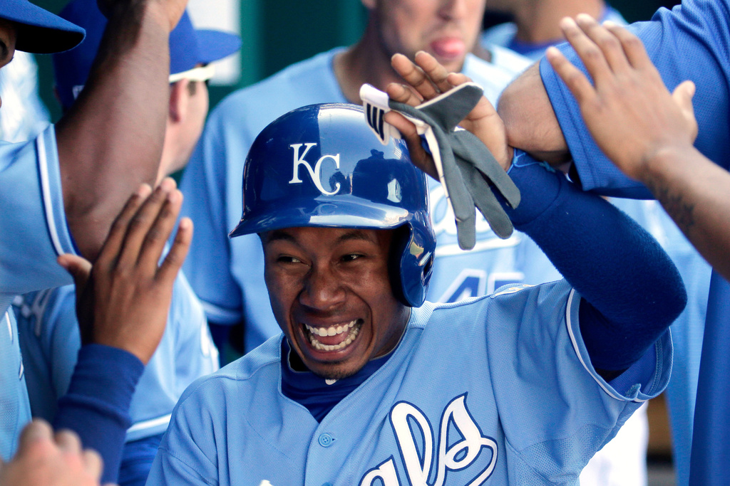 FILE - Kansas City Royals' Terrance Gore (0) celebrates in the dugout after scoring on a double by Alex Gordon during the seventh inning of a baseball game against the Detroit Tigers, Sunday, Sept. 21, 2014, in Kansas City, Mo. (AP Photo/Charlie Riedel, File)