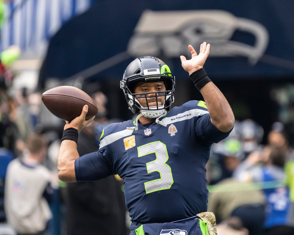 FILE - Seattle Seahawks quarterback Russell Wilson passes the ball during warmups before an NFL football game against the Arizona Cardinals, Nov. 21, 2021, in Seattle. (AP Photo/Stephen Brashear, File)