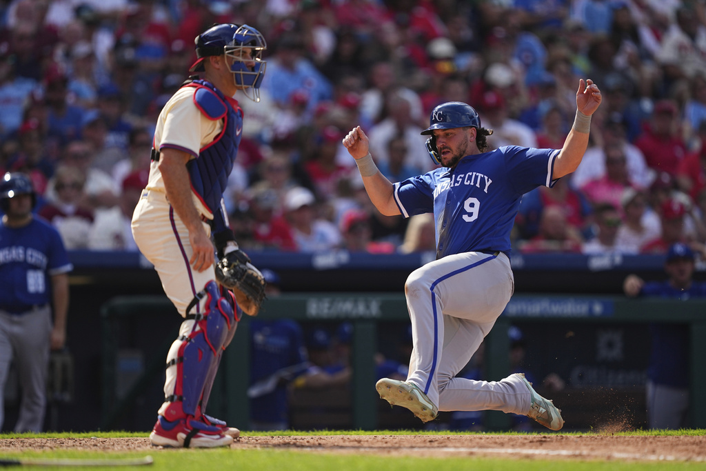Kansas City Royals' Vinnie Pasquantino (9) scores past Philadelphia Phillies catcher J.T. Realmuto, left, off an RBI single by teammate Salvador Perez during the seventh inning of a baseball game, Sunday, Sept. 14, 2025, in Philadelphia. (AP Photo/Matt Rourke)