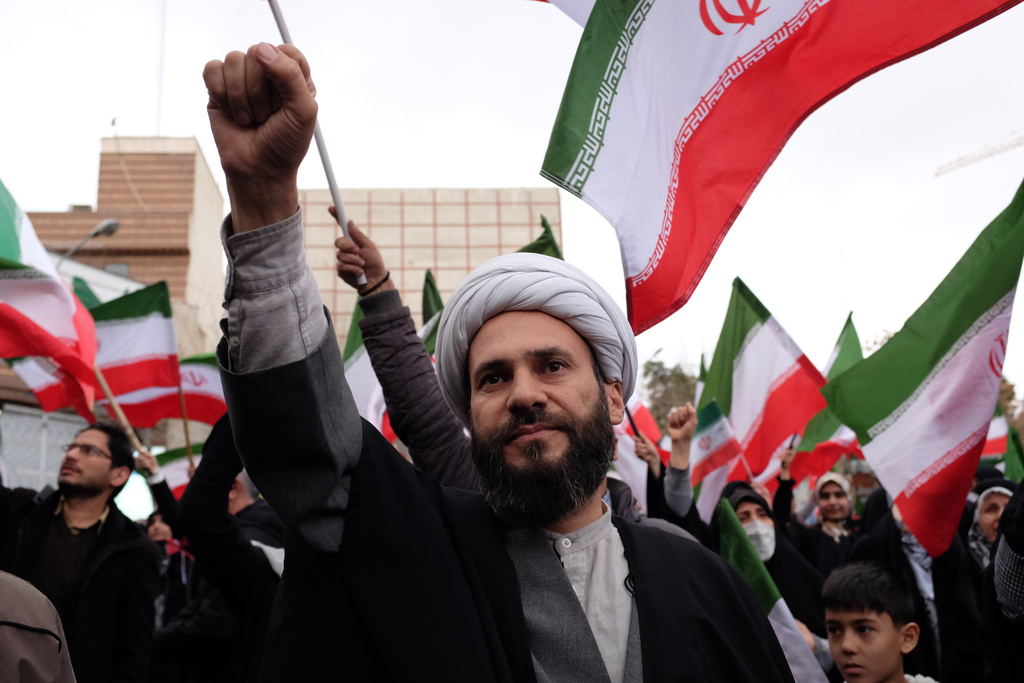A cleric chants slogan in a demonstration in support of the government and against U.S. and Israeli strikes in Tehran, Iran, Saturday, Feb. 28, 2026. (AP Photo/Vahid Salemi)