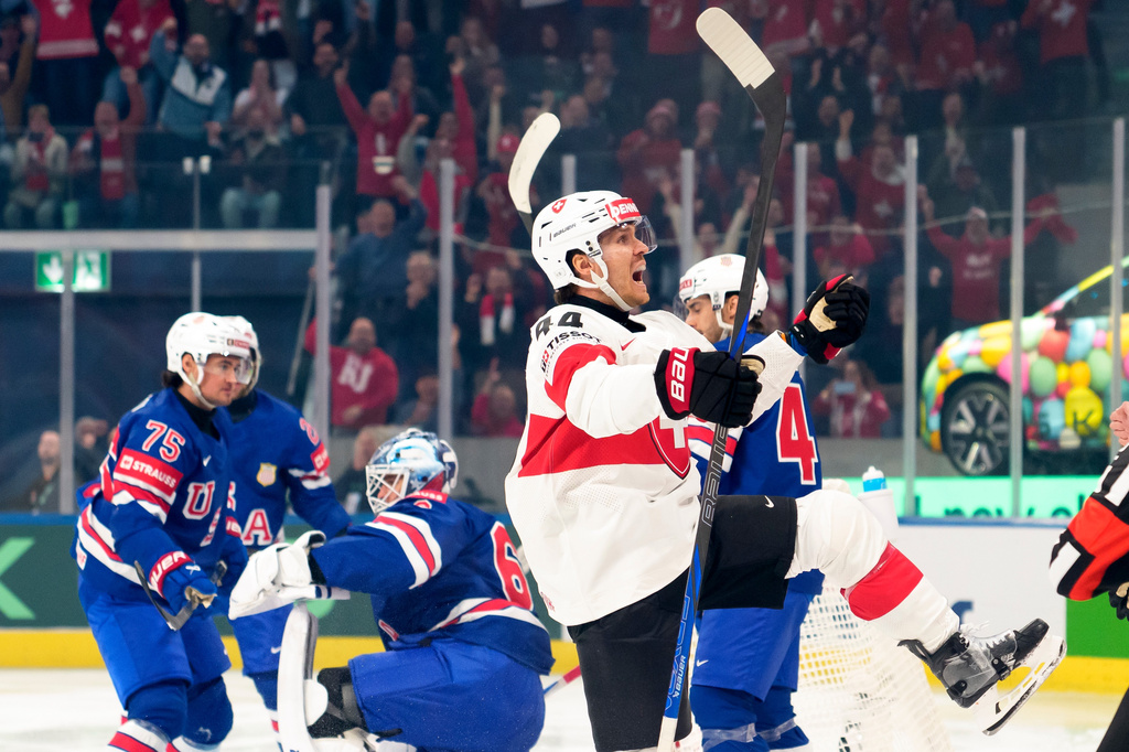 Switzerland's Pius Suter, center, celebrates after scoring during a Group A preliminary round game between United States and Switzerland at the men's ice hockey world championship in Zurich, Switzerland, Friday, May 15, 2026. (Claudio Thoma/Keystone via AP)