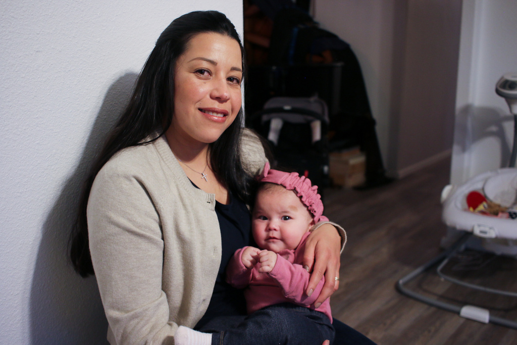 Yurany Dexter holds her 4-month-old daughter, who was recently hospitalized for botulism, at their home in Flagstaff, Ariz. on Wednesday, Nov. 12, 2025. (AP Photo/Cheyanne Mumphrey)