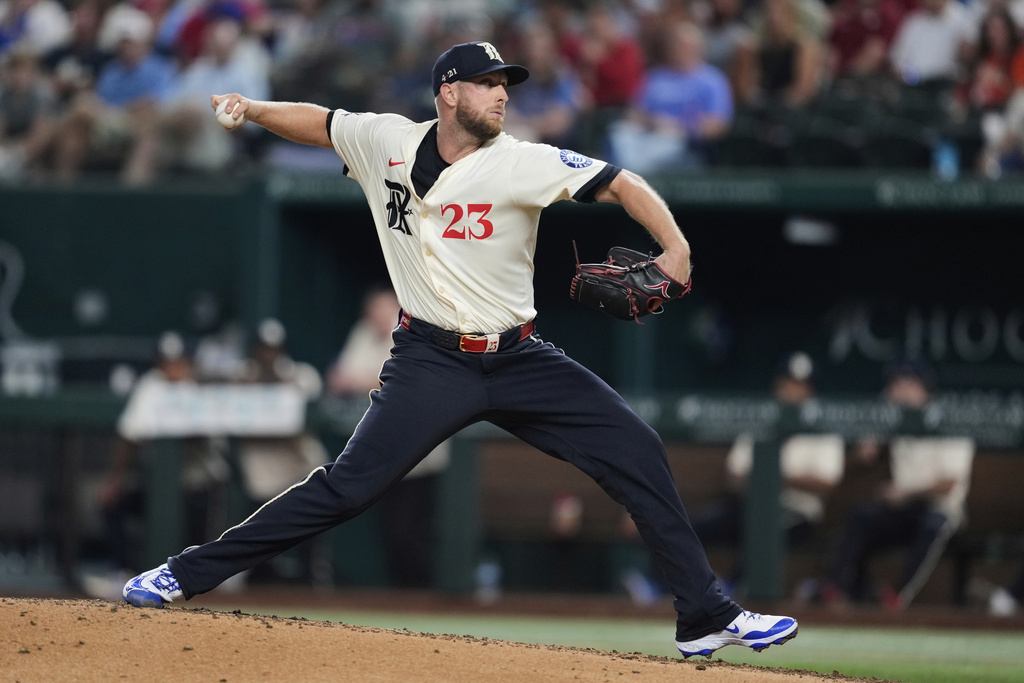 Texas Rangers starting pitcher Merrill Kelly (23) throws to the Houston Astros in the fifth inning of a baseball game Friday, Sept. 5, 2025, in Arlington, Texas. (AP Photo/Tony Gutierrez)
