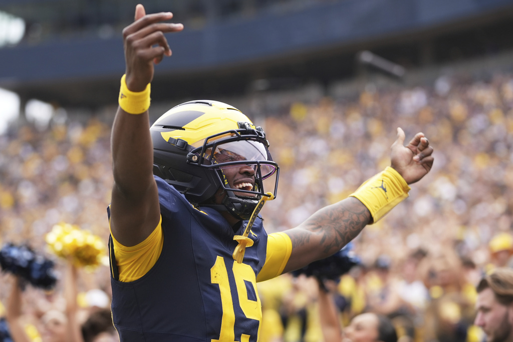 Michigan quarterback Bryce Underwood reacts after scoring a touchdown during the first half of an NCAA college football game against Central Michigan, Saturday, Sept. 13, 2025, in Ann Arbor, Mich. (AP Photo/Ryan Sun)