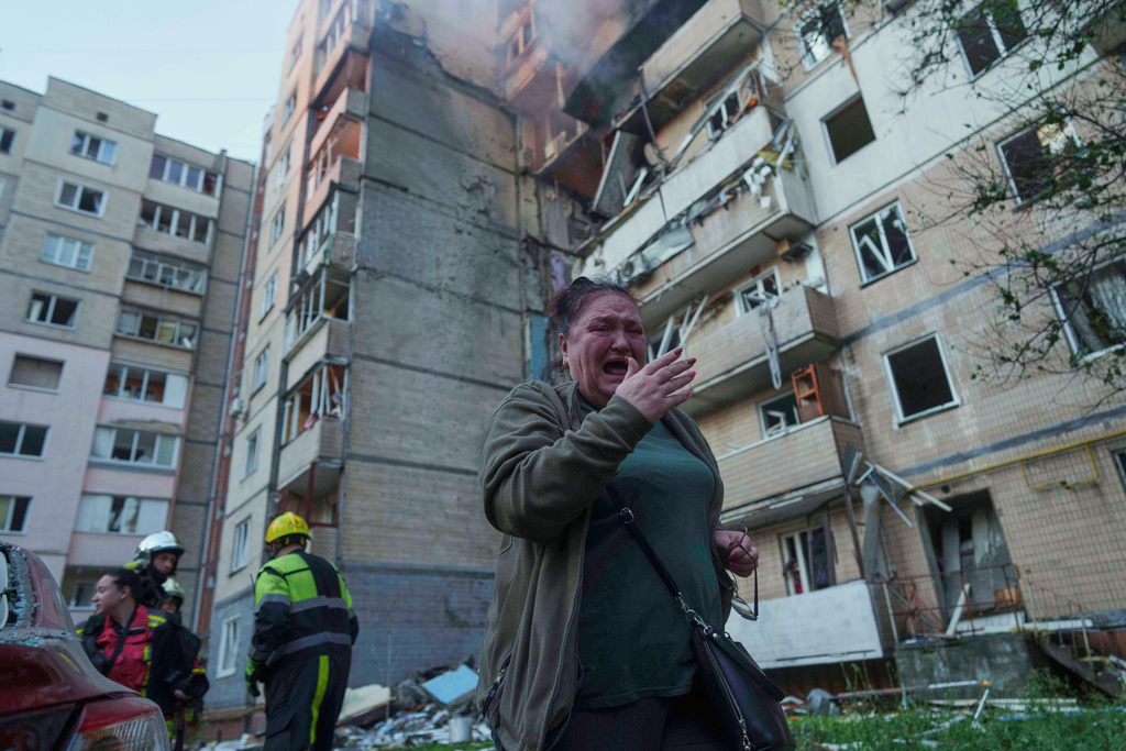A woman reacts in front of a residential building heavily damaged by a Russian strike in Kyiv, Ukraine, on Sunday, Sept. 7, 2025. (AP Photo/Evgeniy Maloletka)