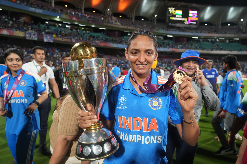 India's captain Harmanpreet Kaur poses with the winning trophy after their win over South Africa in the ICC Women's Cricket World Cup final match in Navi Mumbai, India, Monday, Nov. 3, 2025. (AP Photo/Rafiq Maqbool)