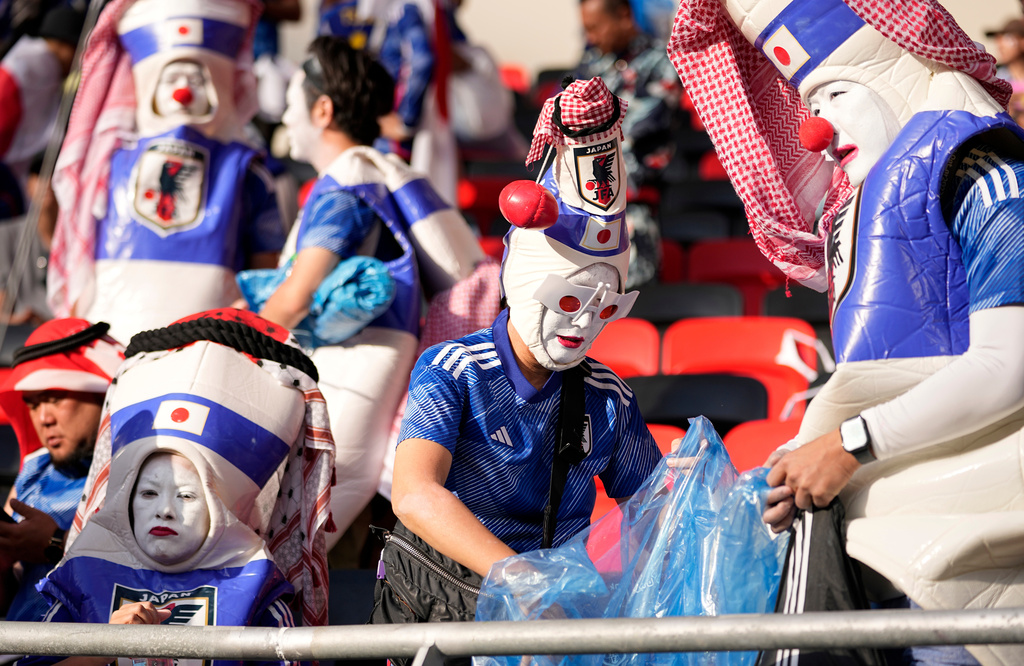 FILE - Japanese fans clean the stadium's stand after Japan was defeated by costa Rica in the World Cup, group E soccer match between Japan and Costa Rica, at the Ahmad Bin Ali Stadium in Al Rayyan , Qatar, on Nov. 27, 2022. (AP Photo/Ariel Schalit, File)