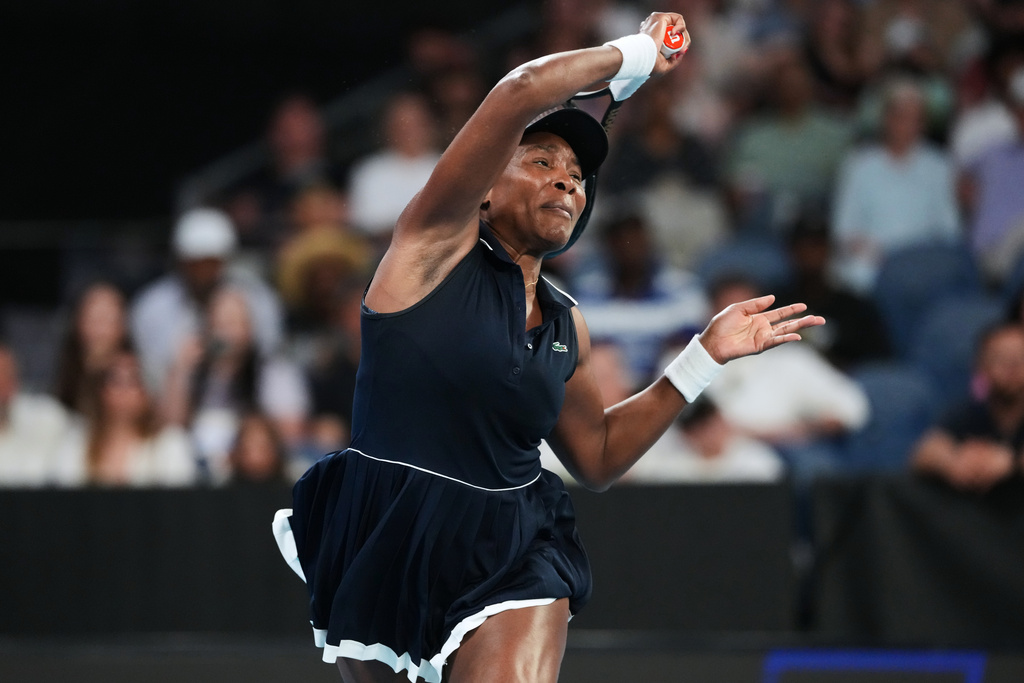 Venus Williams of the U.S. plays a forehand return to Olga Danilovic of Serbia during their first round match at the Australian Open tennis championship in Melbourne, Australia, Sunday, Jan. 18, 2026. (AP Photo/Aaron Favila)