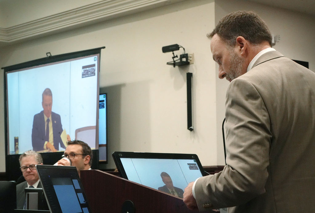 Assistant Ohio Attorney General Matthew Meyer cross examines Sen. Jon Husted, R-Ohio during testimony testifies Zoom during the trial of ex-FirstEnergy Senior Vice President Michael Dowling and former FirstEnergy CEO Chuck Jones in Summit County Common Pleas Judge Susan Baker Ross's courtroom on Wednesday, March 11, 2026 in Akron, Ohio. (Mike Cardew /Akron Beacon Journal via AP, Pool)
