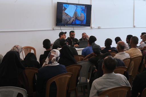 Palestinians watch a screen displaying the examination of the bodies of their relatives, held by Israel during the war, as part of the identification process at Nasser Hospital in Khan Younis, southern Gaza Strip, Tuesday, Oct. 21, 2025. (AP Photo/Jehad Alshrafi) Palestinians watch a screen displaying the examination of the bodies of their relatives, held by Israel during the war, as part of the identification process at Nasser Hospital in Khan Younis, southern Gaza Strip, Tuesday, Oct. 21, 2025. (AP Photo/Jehad Alshrafi)