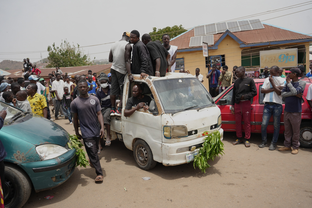 People gather at the scene of Sunday night's gunmen attack in Gari Ya Waye community in the Jos North Nigeria, Monday, March 30, 2026. (AP Photo/Samson Omale)