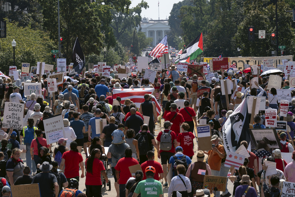 Demonstrators protest against President Donald Trump's deployment of federal law enforcement and National Guard troops in Washington during a march on Saturday, Sept. 6, 2025. (AP Photo/Jose Luis Magana)
