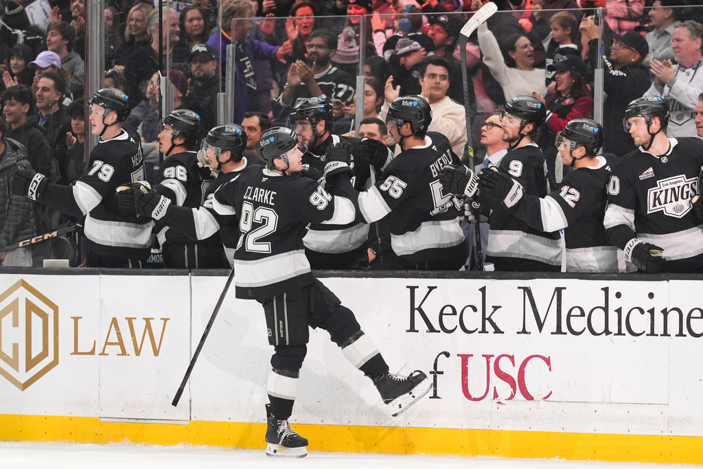 Los Angeles Kings defenseman Brandt Clarke (92) celebrates his goal with teammate during the third period of an NHL hockey game against the Ottawa Senators Monday, Nov. 24, 2025, in Los Angeles. (AP Photo/Jae C. Hong)