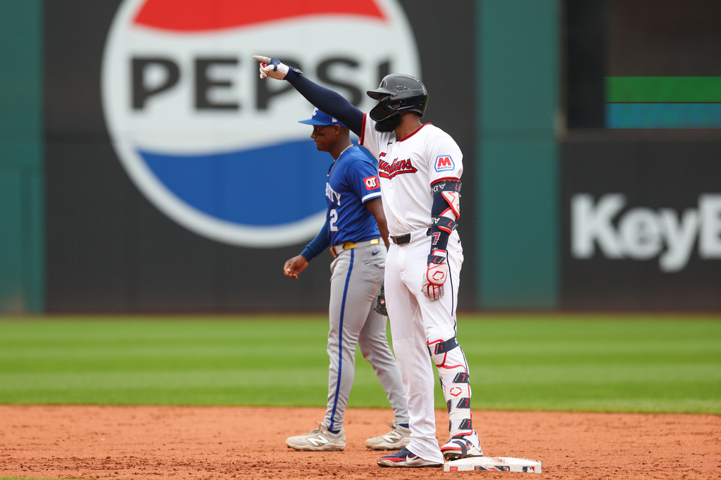 Cleveland Guardians' Jo Adell, right, gestures to the dugout after hitting a two-run double against the Kansas City Royals in the third inning of a baseball game in Cleveland, Sunday, Aug. 30, 2026. (AP Photo/Tim Phillis)