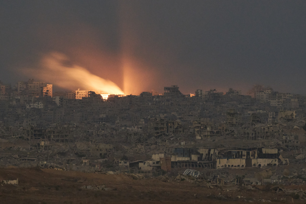 A fire erupts amid buildings destroyed during Israeli ground and air operations, following an Israeli military strike in the northern Gaza Strip, as seen from southern Israel, Monday, Oct. 6, 2025. (AP Photo/Leo Correa)