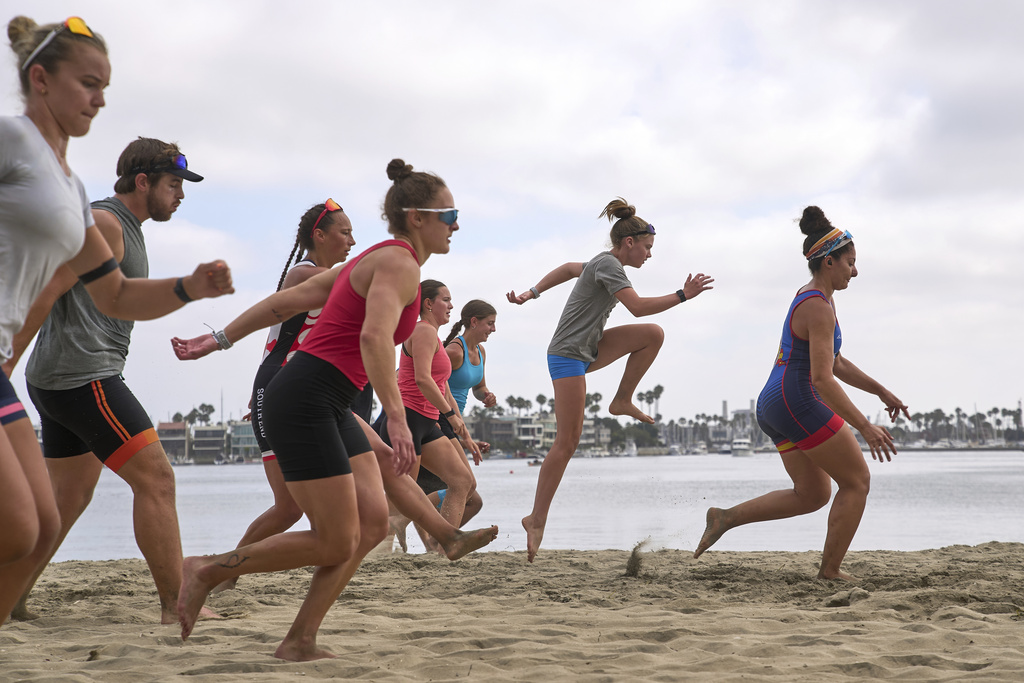Athletes train at a beach sprints camp organized by USRowing in Long Beach, Calif., Sunday, Aug. 10, 2025. (AP Photo/Damian Dovarganes)