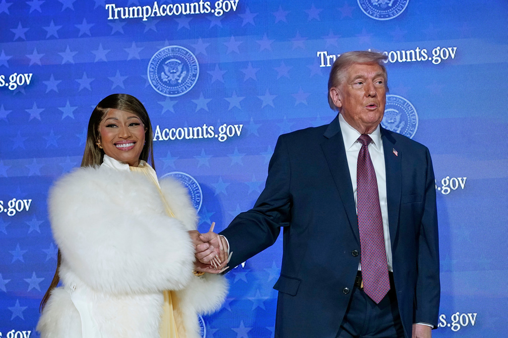 Nicki Minaj and President Donald Trump stand on stage during the launch of a program known as Trump Accounts at the Andrew W. Mellon Auditorium, Wednesday, Jan. 28, 2026, in Washington. (AP Photo/Jose Luis Magana)