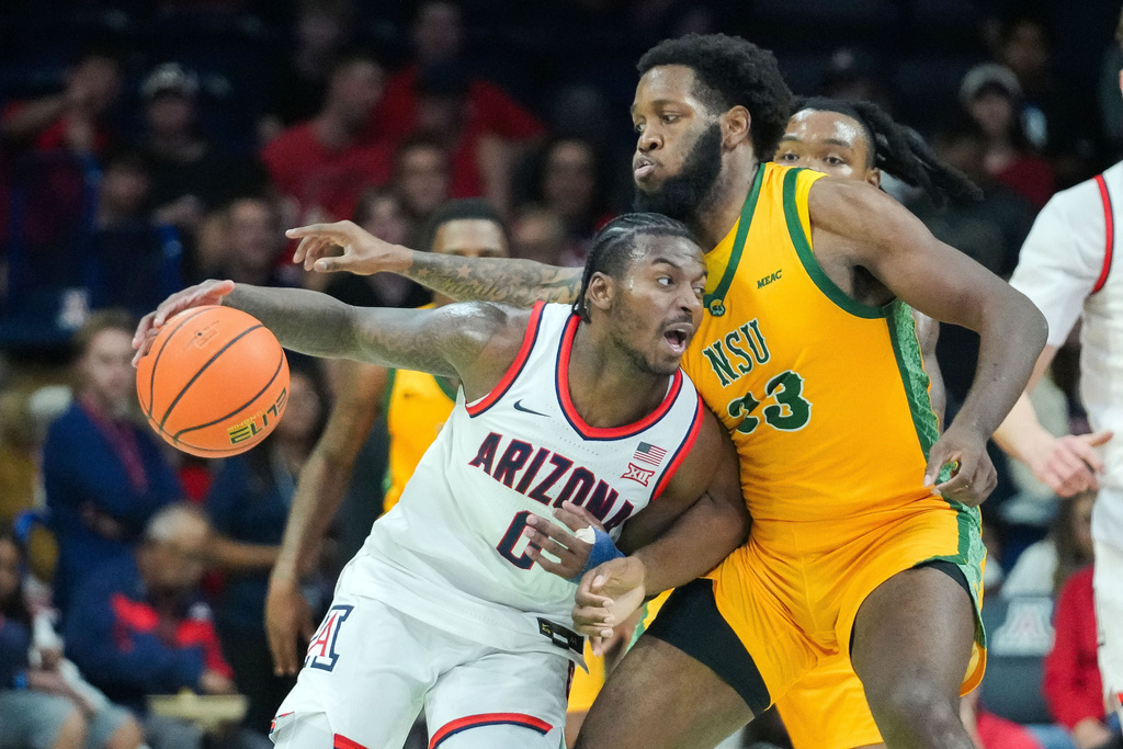 Arizona guard Jaden Bradley (0) tries to work around Norfolk State forward Keyontae Lewis (23) during of an NCAA college basketball game, Saturday, Nov. 29, 2025, in Tucson, Ariz. (AP Photo/Darryl Webb)