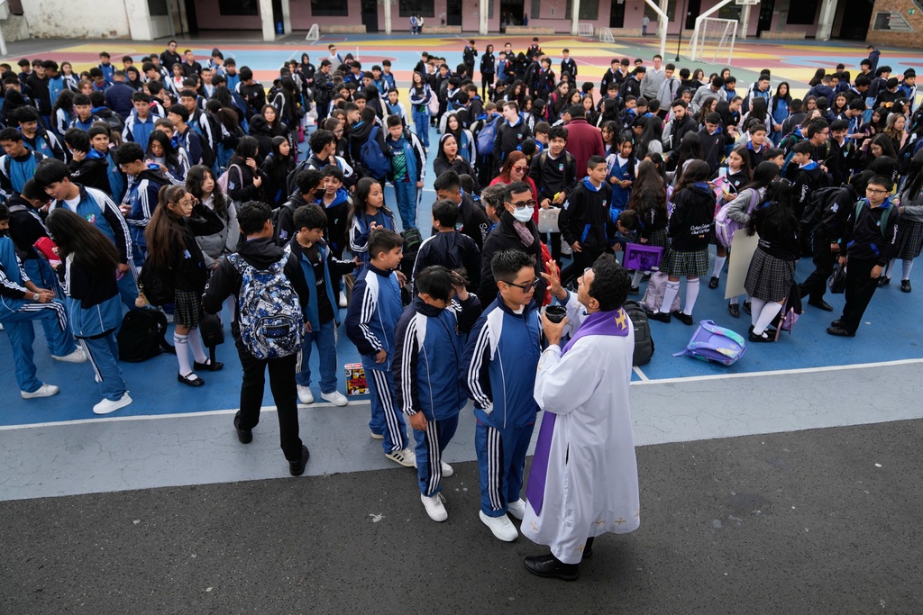 Salesian Priest Martin Mendoza marks a cross on a student forehead during Ash Wednesday Mass at the Juan de el Rizzo Salesian School in Bogota, Colombia, Wednesday, Feb. 18, 2026, the start of the Christian season of Lent, a period of penitence and reflection that leads up to Easter. (AP Photo/Fernando Vergara)