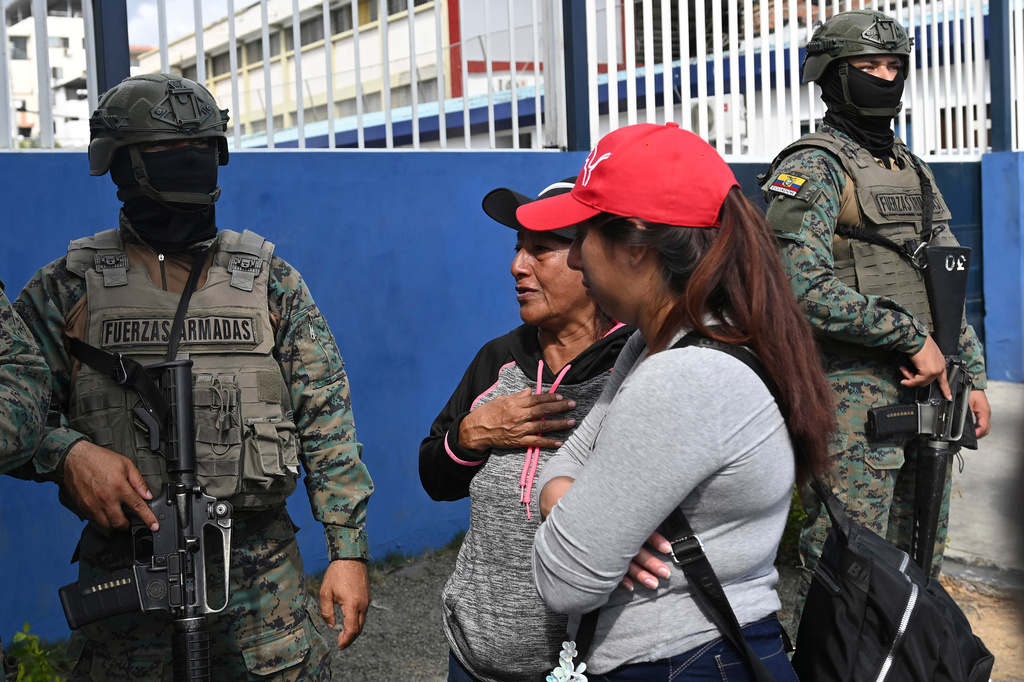 Women seek information about the expected arrival of their relatives who were aboard the Maria Candelaria, a vessel intercepted two days prior by U.S. authorities on suspicion of alleged drug trafficking, at the port in Manta, Ecuador, Monday, Sept. 7, 2026. (AP Photo/Ariel Ochoa)