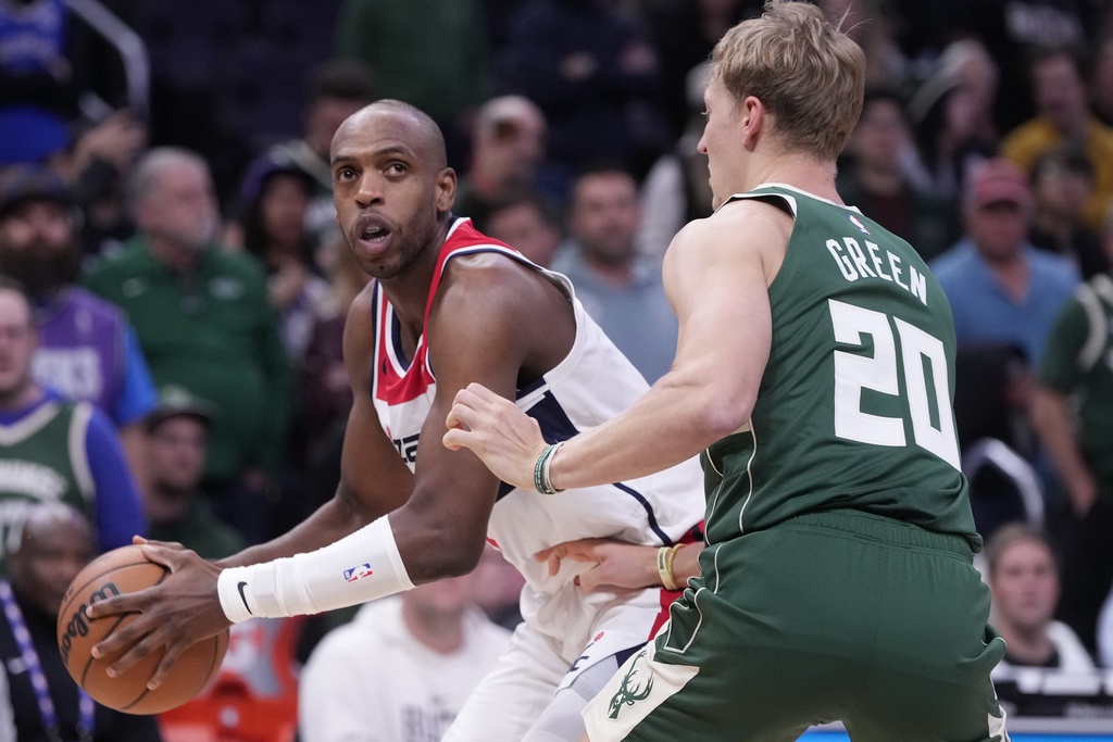 Washington Wizards' Khris Middleton tries to get past Milwaukee Bucks' AJ Green during the first half of an NBA basketball game Wednesday, Oct. 22, 2025, in Milwaukee. (AP Photo/Morry Gash)