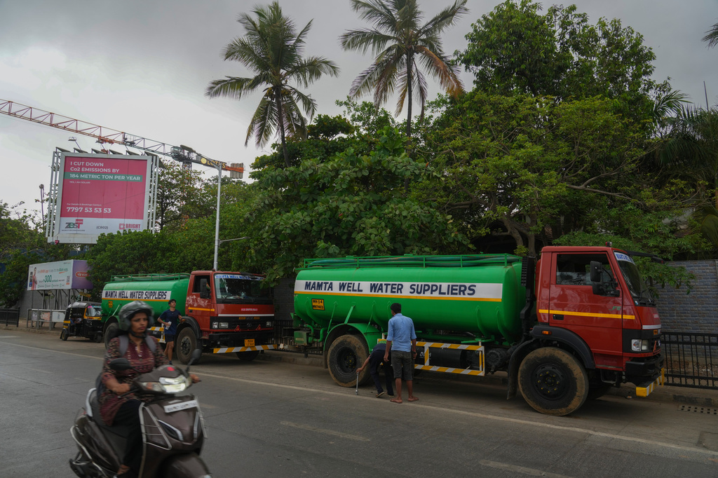 Water tankers are seen outside a construction site in Mumbai, India, Sunday, June 21, 2026. (AP Photo/Rafiq Maqbool)