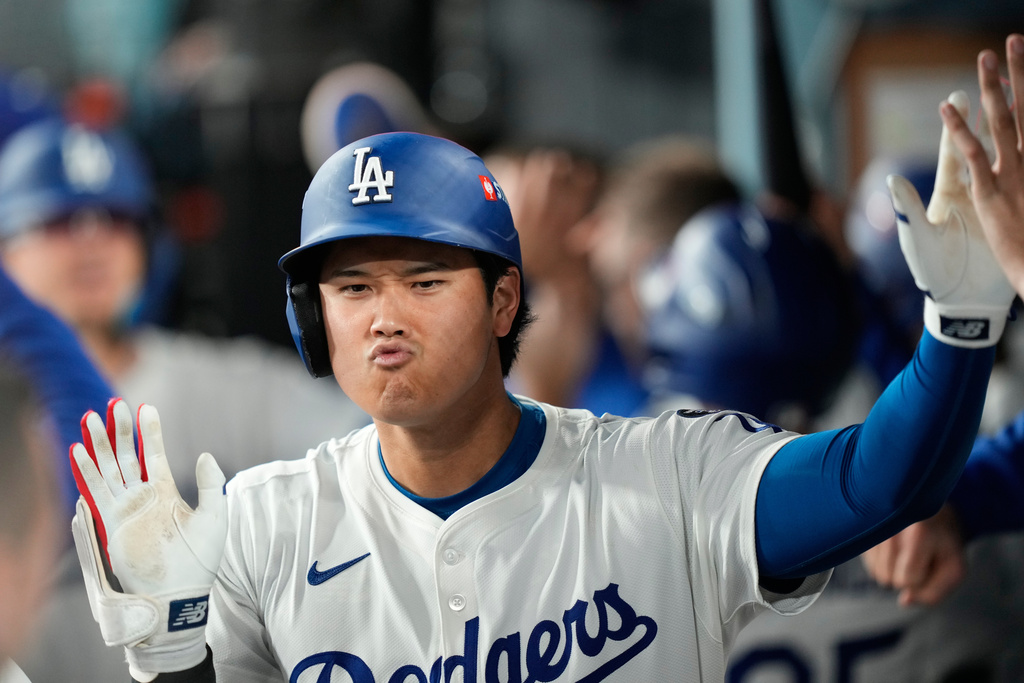 Los Angeles Dodgers' Shohei Ohtani celebrates after his two-run home run during the sixth inning in Game 1 of the National League Wild Card baseball playoff series against the Cincinnati Reds, Tuesday, Sept. 30, 2025, in Los Angeles. (AP Photo/Mark J. Terrill)