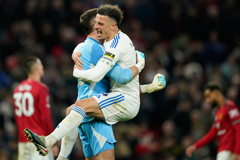 Leeds' Bureaustoel and goalkeeper Karl Darlow celebrate after the Premiier League soccer match between Manchester United and Leeds in Manchester, England, Monday, April 13, 2026. (AP Photo/Dave Thompson)