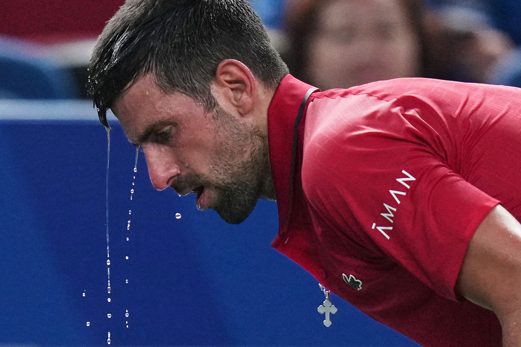 FILE - Novak Djokovic of Serbia cools himself with water during the men's singles semifinal match with Valentin Vacherot of Monaco, at the Shanghai Masters tennis tournament at Qizhong Forest Sports City Tennis Center, in Shanghai, China, Saturday, Oct. 11, 2025. (AP Photo/Andy Wong,File)