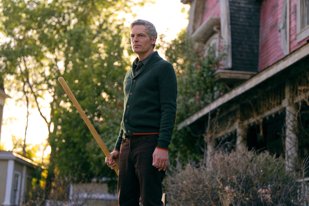 This image released by Peacock shows Justin Kirk in a scene from "The Burbs." (Elizabeth Morris/Peacock via AP)