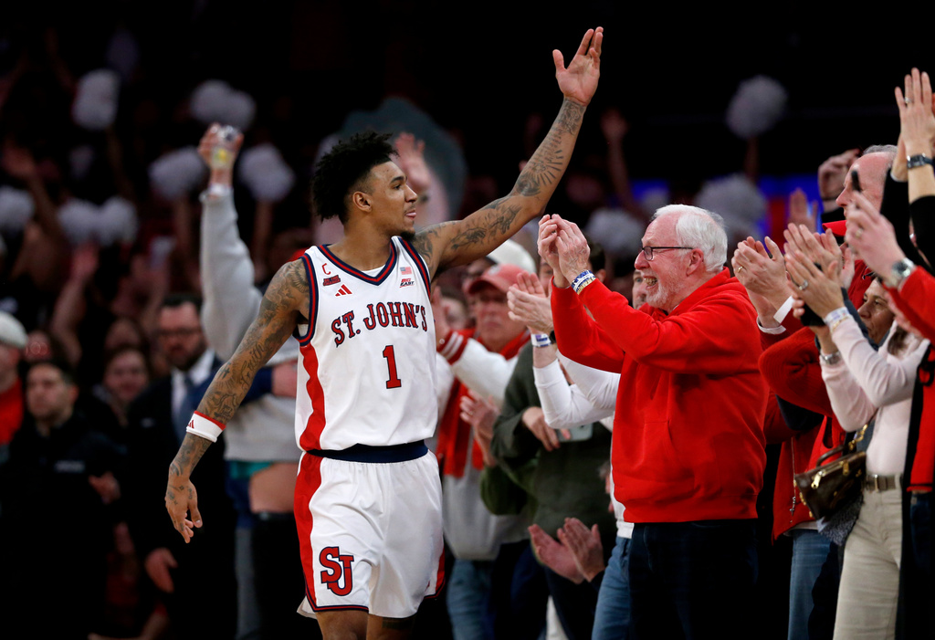 St. John's forward Dillon Mitchell (1) celebrates with fans during the closing seconds of an NCAA college basketball game against UConn, Friday, Feb. 6, 2026, in New York. (AP Photo/John Munson)