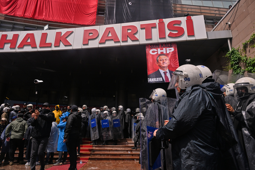 Police officers stand at Turkey's main opposition Republican People's Party (CHP) headquarters after entering to evict supporters gathered inside for party leader Ozgur Ozel, in Ankara, Sunday, May 24, 2026. (AP Photo/Ali Unal)