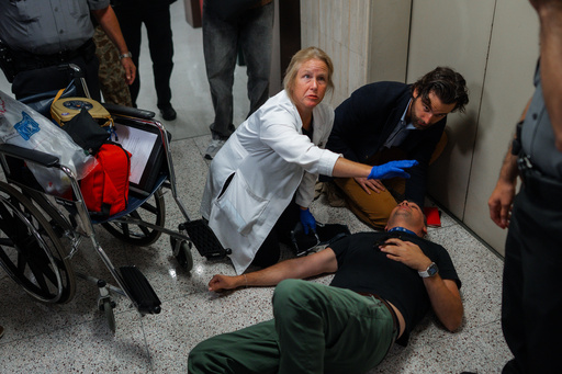 Journalist L. Vural Elibol receives medical assistance after being shoved by federal agents in immigration court on Tuesday, Sept. 30, 2025, in New York. (AP Photo/Olga Fedorova) Journalist L. Vural Elibol receives medical assistance after being shoved by federal agents in immigration court on Tuesday, Sept. 30, 2025, in New York. (AP Photo/Olga Fedorova)