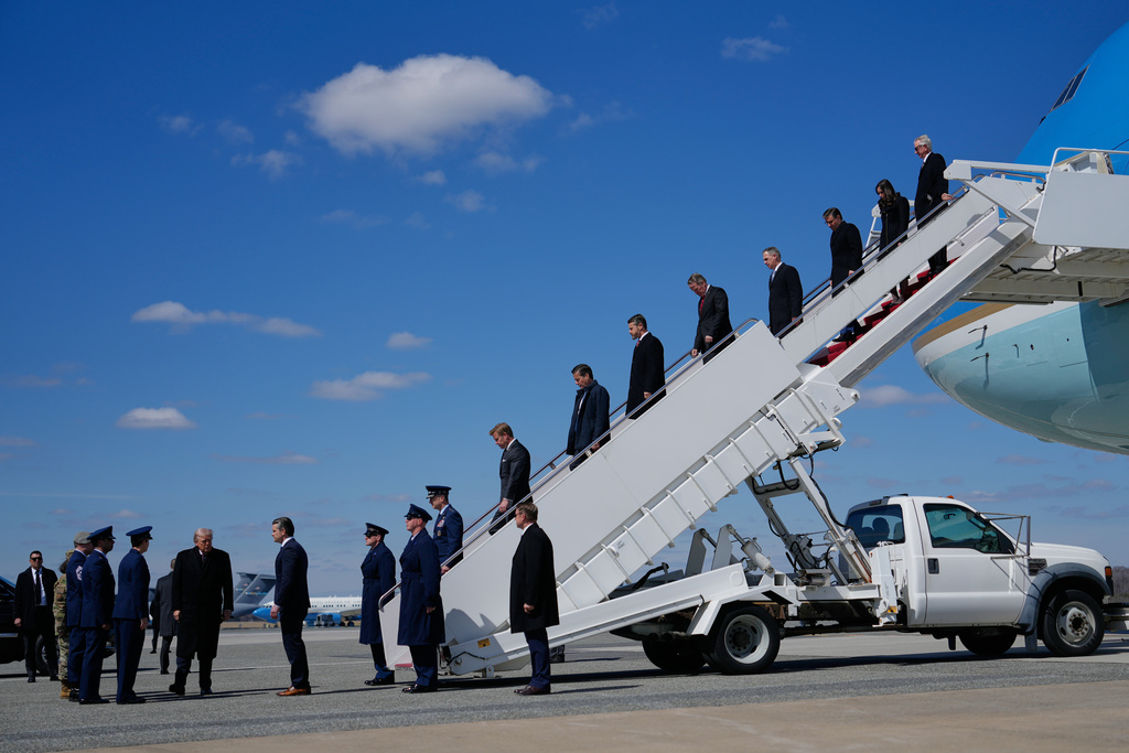 President Donald Trump arrives with Defense Secretary Pete Hegseth, Chairman of the Joint Chiefs of Staff Gen. Dan Caine and members of Congress, on Air Force One, Wednesday, March 18, 2026, at Dover Air Force Base, Del., to attend the casualty return for the six crew members of an Air Force refueling aircraft who died when their plane crashed in western Iraq while supporting operations against Iran. (AP Photo/Julia Demaree Nikhinson)