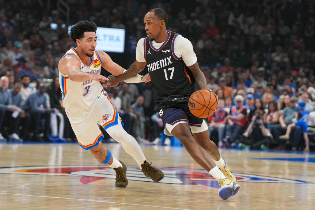 Phoenix Suns guard Jamaree Bouyea (17) pushes past Oklahoma City Thunder guard Jared McCain (3) during the first half of an NBA basketball game, Sunday, April 12, 2026, in Oklahoma City. (AP Photo/Kyle Phillips)