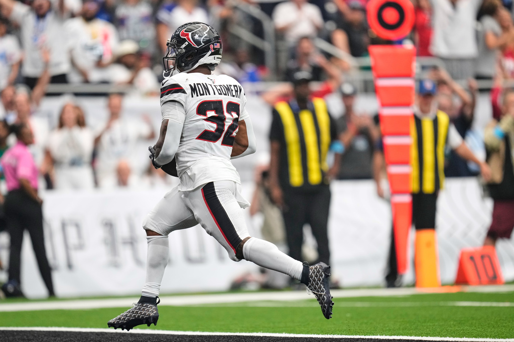 Houston Texans running back David Montgomery (32) runs the ball into the end zone for a touchdown during the first half of an NFL football game against the Buffalo Bills, Sunday, Sept. 13, 2026, in Houston. (AP Photo/Ashley Landis)