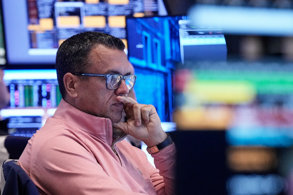 Trader Robert Finnerty Jr. works on the floor of the New York Stock Exchange, Friday, Nov. 21, 2025. (AP Photo/Richard Drew)