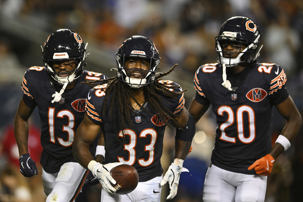 Chicago Bears running back Ian Wheeler (33), Maurice Alexander (13) and Jahdae Walker (20) celebrate after Wheeler rushed for a touchdown in the second half of a preseason NFL football game against the Buffalo Bills Sunday, Aug. 17, 2025, in Chicago. (AP Photo/Paul Beaty)